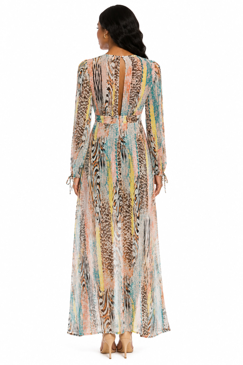 Woman wearing a long, patterned dress with a white background