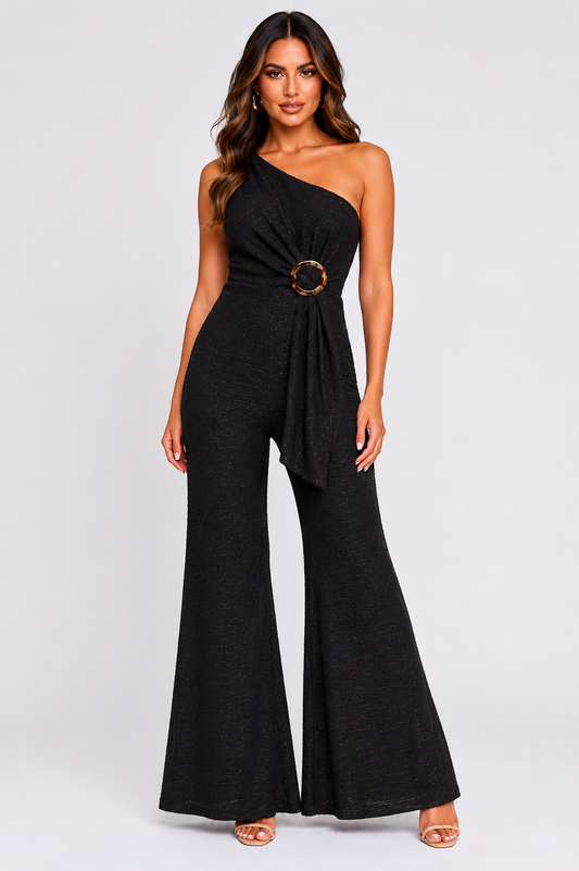 Woman wearing a black one-shoulder jumpsuit on a white background