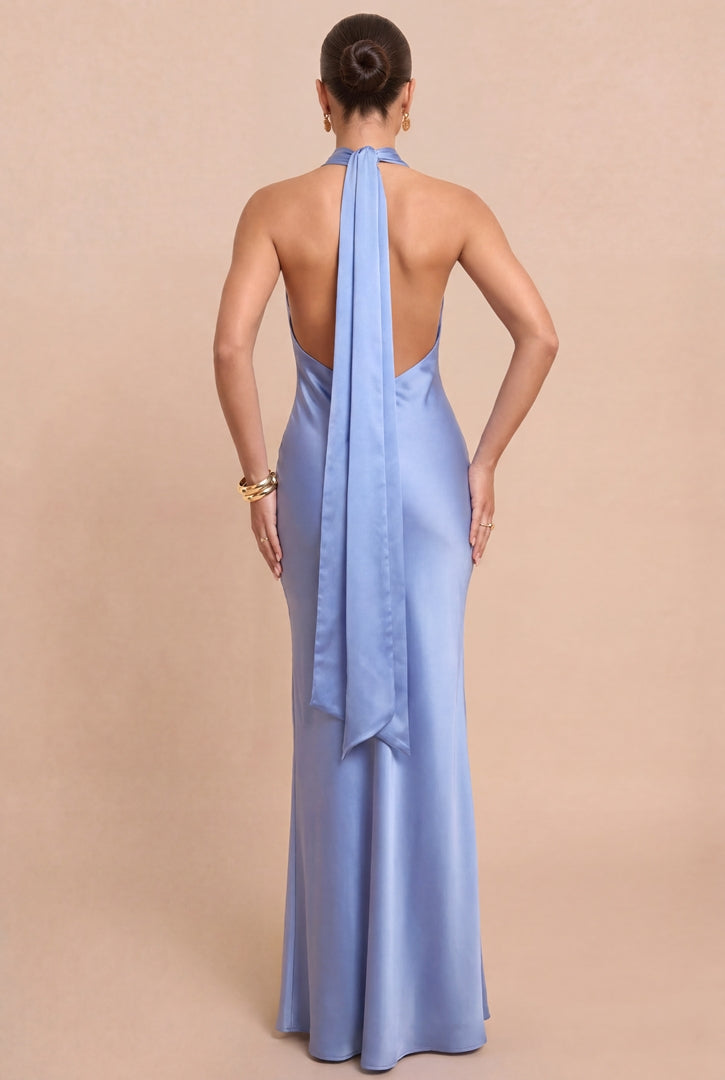 Woman wearing a light blue halter neck gown with a beige background